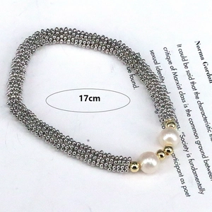 Detail view of handmade beaded bracelet with pearls and metal beads showing 17cm length
