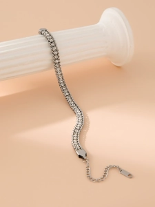 Close-up of sparkling rhinestone double-row bracelet on a white Roman column prop