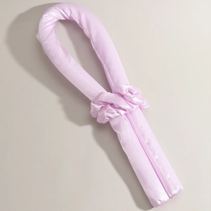 Detail view of a pink silk heatless hair curler set with matching scrunchies for sleeping