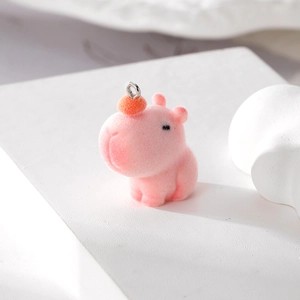 Pink flocked capybara pendant charm with red pompom and silver metal ring accessory