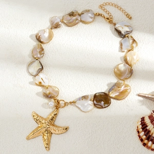Detailed shot of ocean theme necklace with golden starfish and iridescent shell beads
