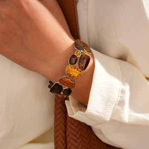 Close-up of vintage resin geometric panel bracelet with silver frames on a female wrist