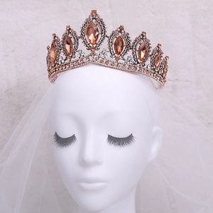 Detailed view of Baroque bridal crown with amber crystals on a white bridal veil