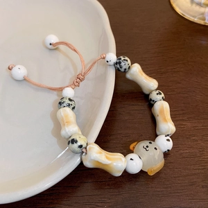 Handmade ceramic beaded bracelet with cute dog charm and adjustable woven cord strap