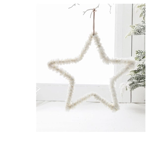 Close-up of a white plush star-shaped Christmas ornament hanging on a delicate branch