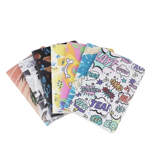 Group display of passport covers in various patterns including floral, retro, and pop art