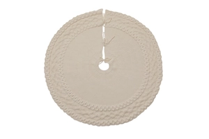 Detail of cream white cable knit Christmas tree skirt with decorative patterns and ties