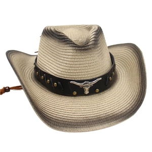 Detail of western straw hat with faux leather band and metallic bull head ornament