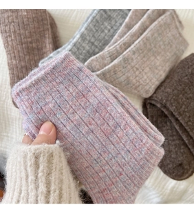 Detail of thick ribbed wool blend socks in pink, brown, and grey soft gradient colors
