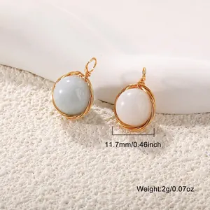 Close-up of gold-plated wire wrapped natural stone pendant measuring 11.7mm diameter