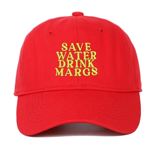 Detailed close-up of neon yellow Save Water Drink Margs embroidery on a red baseball cap