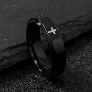 Minimalist black stainless steel cross ring with faceted surface on dark stone