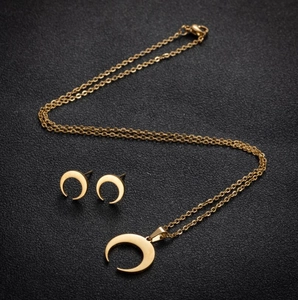 Golden crescent moon jewelry set with matching pendant necklace and stud earrings