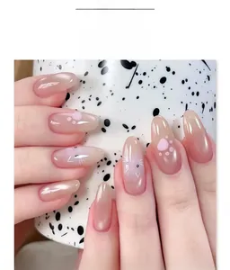 Detailed close-up of nude pink gradient press-on nails with cute cat paw hand-painted art