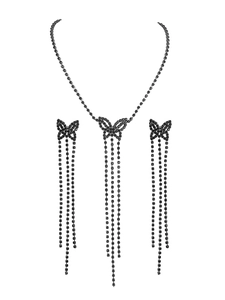 Detailed close-up of butterfly necklace and tassel earrings set with black crystals