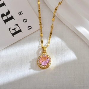 Elegant gold necklace with a large round pink gemstone pendant and diamond halo