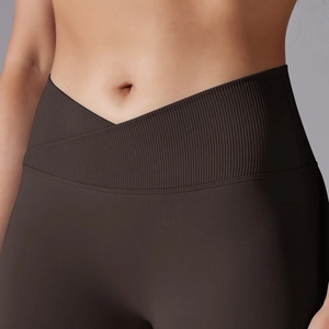 Close-up of deep brown yoga pants featuring a seamless V-cut criss-cross ribbed waistband