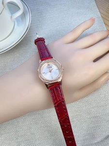Detail of red crocodile leather strap and rose gold diamond-set octagonal watch case