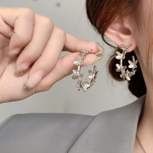 Elegant silver butterfly hoop earrings crafted with textured hollow wing butterfly charms