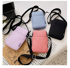 Detailed top view of compact nylon crossbody bags in blue, black, purple, and pink colors