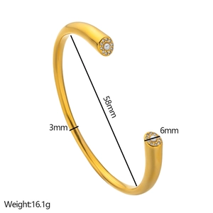 Detail view of gold C-shaped titanium bracelet with pearl and diamond size measurements