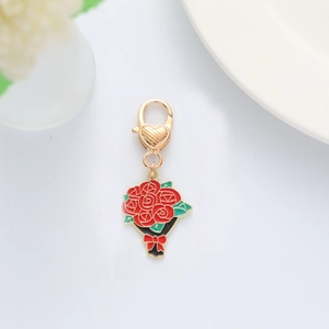 Detailed close-up of a red rose flower keychain with gold accents and heart lobster clasp