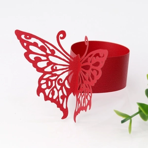 Macro detail of red laser-cut butterfly napkin ring made of pearlized specialty paper