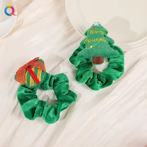 Detail of Christmas tree and gift box plush scrunchies in green velvet with embroidery