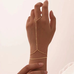 Close-up of elegant 18K gold plated double layer finger chain bracelet on woman hand