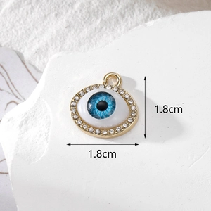 Detailed macro view of 1.8cm gold evil eye pendant with blue resin and white zircons