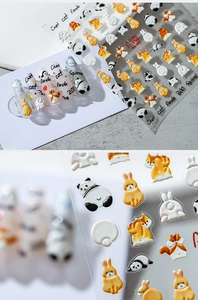 Detailed 3D embossed nail stickers featuring cute panda and fox cartoon animal designs