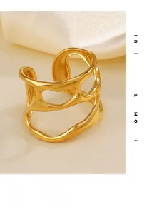 Detailed view of chunky irregular hollow gold ring on white silk fabric with soft light