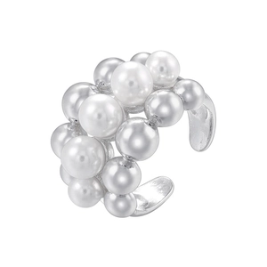 Macro shot of silver ear cuff featuring multiple white pearls on a sleek metallic frame