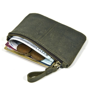 Detail view of a green leather coin purse showing interior slots for cash and cards