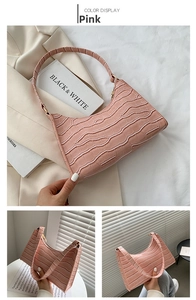 Detail shot of the pink crocodile pattern texture on a minimalist PU leather hobo bag