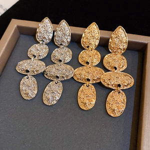 Vintage hammered metal drop earrings in gold and silver finish with geometric texture