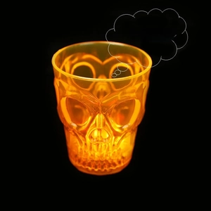 Macro shot of an orange glowing skull shot glass with double-sided relief design