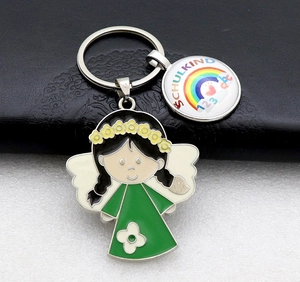 Detail of schoolchild metal keychain with angel charm and rainbow Schulkind pendant