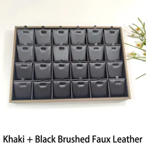 Detailed top view of 24-compartment jewelry display tray with khaki frame and black leather