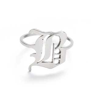 Macro shot of gothic letter B engraved on a polished stainless steel vintage ring