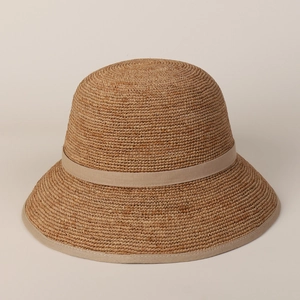 Detailed view of the caramel woven raffia sun hat featuring a classic ribbon edge