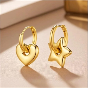 Golden titanium steel hoop earrings with asymmetric heart and star charms on beige surface
