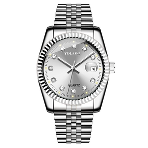 Close-up of silver quartz watch with diamond-cut bezel, date display and five-link strap