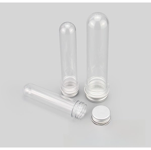 Detailed view of transparent PET plastic tubes with silver aluminum screw caps and seal liners