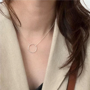 Minimalist S925 sterling silver geometric circular necklace worn by a woman on a chain