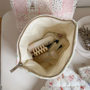 Detailed top view of a large capacity quilted cotton cosmetic bag with floral rabbit prints