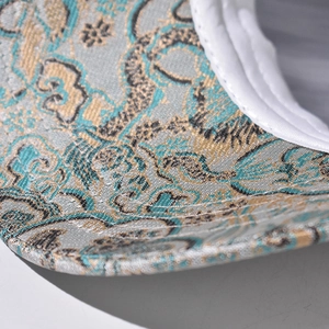Close-up of traditional Chinese dragon and cloud embroidery on a baseball cap brim