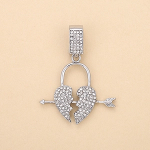 Macro shot of silver iced out broken heart pendant with arrow and sparkling crystals