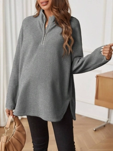 Detail of grey maternity pullover featuring a half-zip neckline and soft knit texture