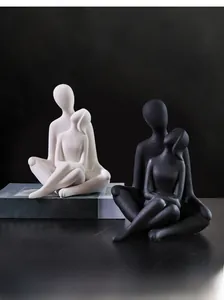 Detail of minimalist ceramic couple sculptures in black and white matte finish